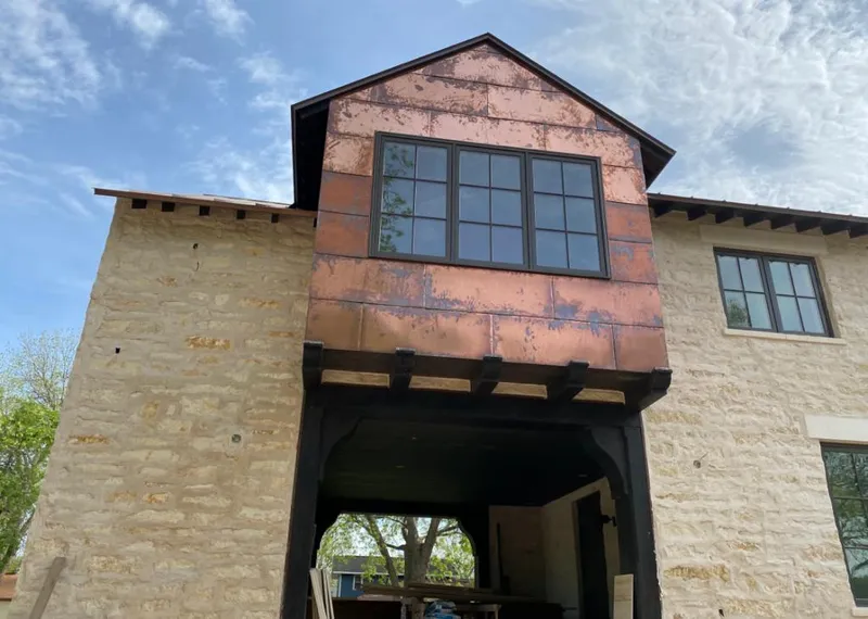 Copper metal panel facade on a stone building for Skylight Installation in Othello